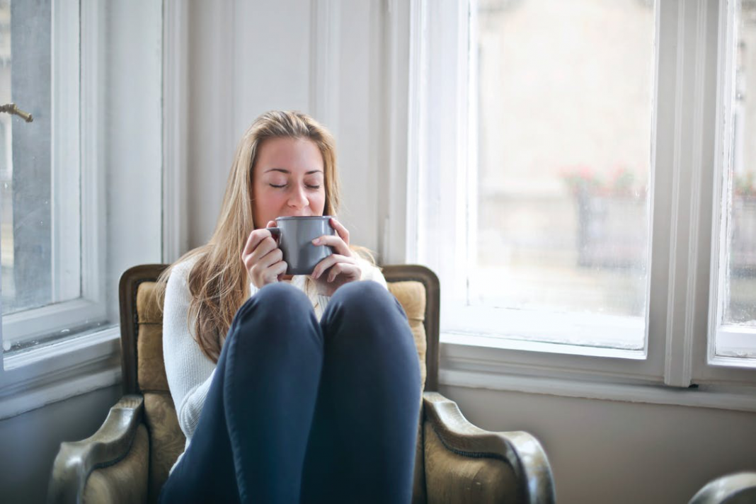 Woman Having a Beverage by the Window