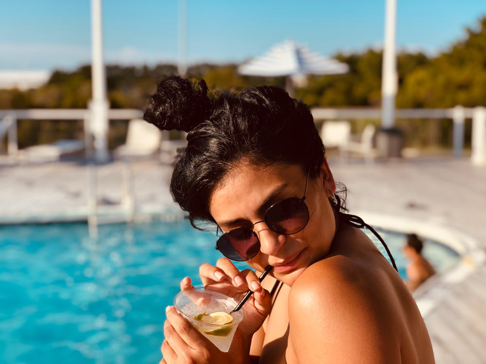 Woman Sipping a Drink by the Pool