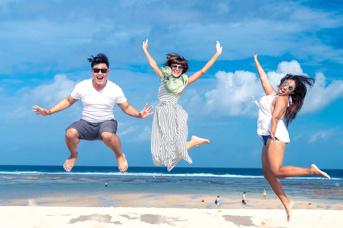 Happy People Jump Posing on a Beach
